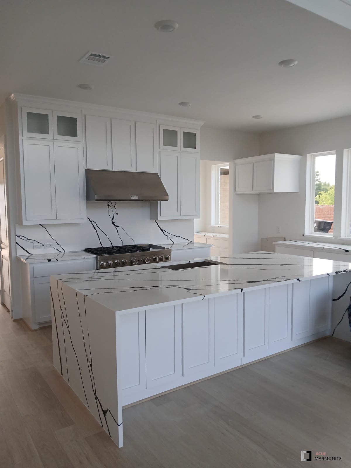 Panda quartz waterfall island and matching backsplash