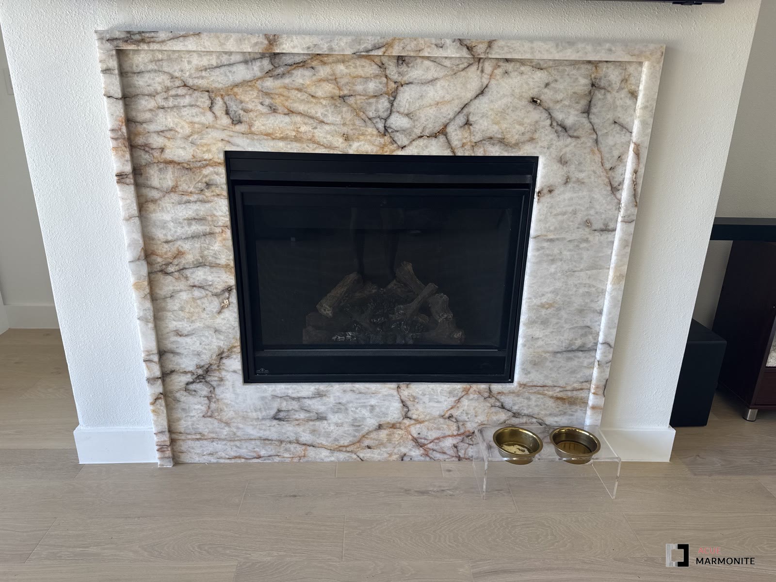 Cream and gold marble fireplace with wood mantle